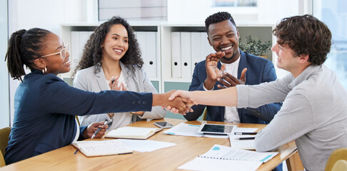 Poster - Concluding the meeting on a high note. Shot of businesspeople shaking hands during a meeting in an office.