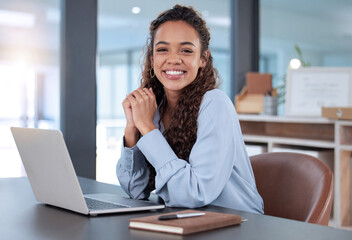 i love what i do. cropped portrait of an attractive young businesswoman working on her laptop while 
