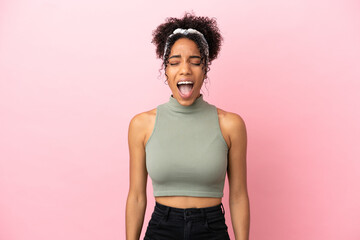 Sticker - Young latin woman isolated on pink background shouting to the front with mouth wide open