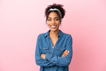 Wall Mural - Young latin woman isolated on pink background with arms crossed and looking forward