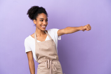 Sticker - Restaurant waiter latin woman isolated on purple background giving a thumbs up gesture