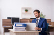 © Elnur - Young male employee and too much work in the office