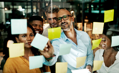 Sticker - Transforming business into a marketing machine. Shot of a group of businesspeople having a late night brainstorming session in a modern office.