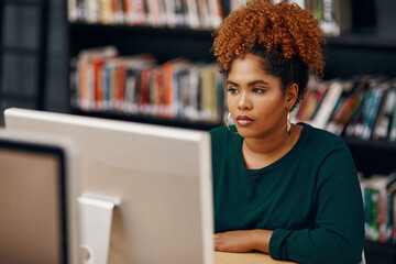 Aufkleber - Prepping for her final exams. High angle shot of a young female university student studying in the library.