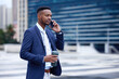 © C Daniels/peopleimages.com - If you want to achieve greatness stop asking for permission. Shot of a young businessman walking and using a phone in the city.