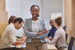 © Delcio F/peopleimages.com - With this team behind me, its easy to be confident. Cropped portrait of an attractive young businesswoman standing with her arms folded in the boardroom with her colleagues in the background.