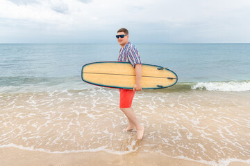 Portrait of young adult stylish caucasian man wear casual shirt and sunglasses enjoy having leisure time surfing at ocean seaside travel vacation tropical resort. Male surfer person surfboard coast