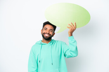 Wall Mural - Young Brazilian man isolated on white background holding an empty speech bubble