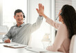 © Beaunitta Van Wyk/peopleimages.com - Great job. Shot of two young call center agents giving each other a high five in an office at work.