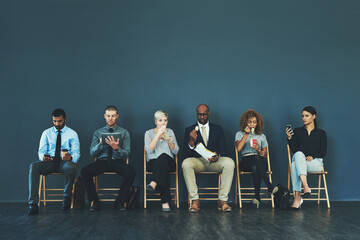 Aufkleber - Do what you must to be prepared. Shot of a group of well-dressed business people seated in line while waiting to be interview.