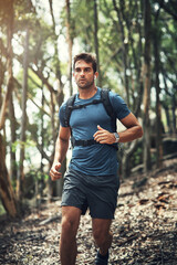 Poster - Hiking is his favourite hobby. Cropped shot of a handsome young man running during his hike in the mountains.