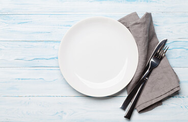 Sticker - Empty plate and silverware on wooden table