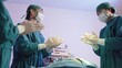 © sorapop - Group of surgery doctors in sterile gloves and protective face masks standing applause by patient after successful surgical operation room at hospital, medical team doctor clapping hands congratulated