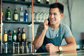 Poster - Were open all day. Cropped shot of a young man taking orders via cellphone in his coffee shop.