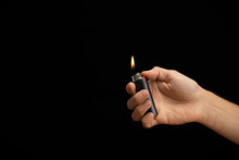 Hand Of A Man Handing A Lit Lighter