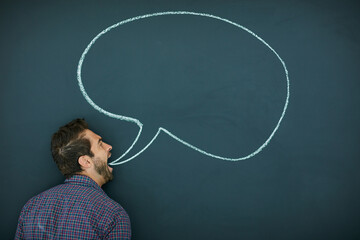 Poster - Im getting this off my chest. Shot of a young man standing in front of a blackboard with a speech bubble drawn on it.