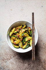 Canvas Print - Chinese smashed cucumber salad with chili peppers and sesame seeds, copy space.