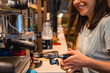 © unai - Smiling unrecognizable female cafeteria waitress preparing coffee in a coffee machine, covid restrictions are lifted and the mandatory use of face masks is removed