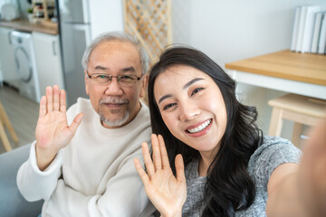 Wall Mural - Asian lovely family, young daughter use phone selfie with older father