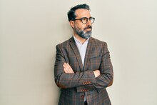 Middle Age Man With Beard And Grey Hair Wearing Business Jacket And Glasses Smiling Looking To The Side And Staring Away Thinking.