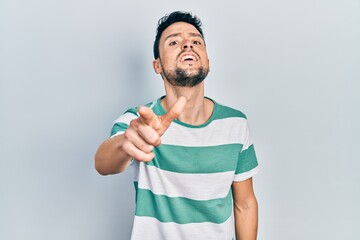 Poster - Young hispanic man wearing casual clothes pointing displeased and frustrated to the camera, angry and furious with you