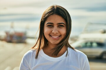 Poster - Young latin girl smiling happy standing at the city.