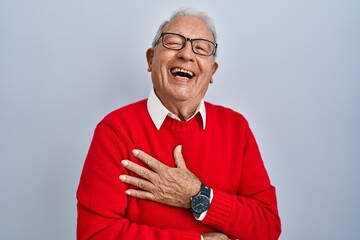 Poster - Senior man with grey hair standing over isolated background smiling and laughing hard out loud because funny crazy joke with hands on body.