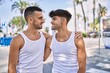 © Krakenimages.com - Young hispanic couple smiling happy hugging at the city.