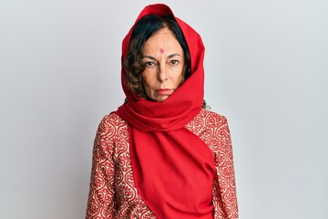 Poster - Middle age hispanic woman wearing tradition sherwani saree clothes depressed and worry for distress, crying angry and afraid. sad expression.