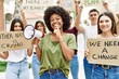 © Krakenimages.com - Group of young friends protesting and giving slogans at the street serious face thinking about question with hand on chin, thoughtful about confusing idea