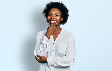 Sticker - African american woman with afro hair wearing casual white t shirt looking confident at the camera smiling with crossed arms and hand raised on chin. thinking positive.