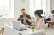 Leinwandbild Motiv Business people making deal. Company employees greeting each other. Happy businessman and businesswoman sitting at office desk table with notebook PC fist bumping after job well done. Teamwork concept