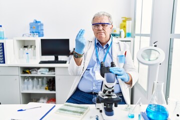 Sticker - Senior caucasian man working at scientist laboratory doing italian gesture with hand and fingers confident expression