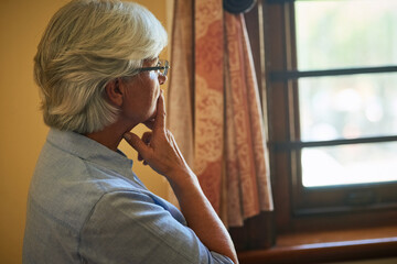 Poster - Taking some time to reflect deeply. Cropped shot of a senior woman looking out the window at home.