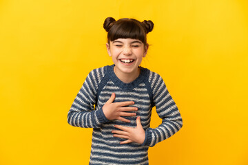 Wall Mural - Little caucasian girl isolated on yellow background smiling a lot