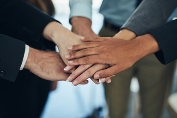 Poster - Stand together, win together. Cropped shot of a group of businesspeople joining their hands in solidarity.