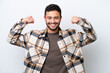 © luismolinero - Young Brazilian man isolated on white background doing strong gesture
