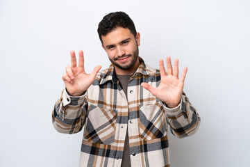 Wall Mural - Young Brazilian man isolated on white background counting eight with fingers