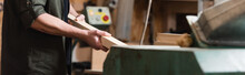 Cropped View Of Furniture Designer Holding Wooden Plank In Woodwork Studio, Banner.