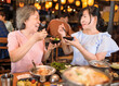 © Tom Wang - Happy mother and daughter celebrating mothers day at restaurant