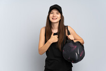 Young Ukrainian Sport Girl With Sport Bag Isolated On Grey Background Giving A Thumbs Up Gesture