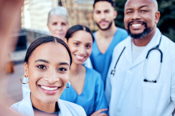 Sticker - Work selfies to brighten up our day. Shot of a group of doctors taking a selfie in the city.