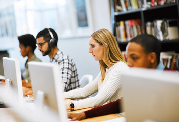 Aufkleber - We are more prepared than ever. Shot of a group young students working on computers and making notes in a library.