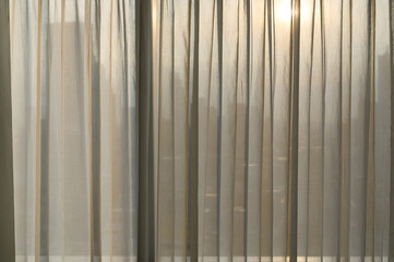 Wall Mural - Sheer curtains with cityscape onbackground. transparent curtain in cozy room home, interior design concept.