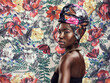 © Valerie Murray/peopleimages.com - Just call me Your Majesty. Studio shot of a beautiful young woman wearing a traditional African head wrap against a floral background.