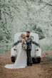 The hipster groom and a blonde bride in a Park.