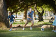 Giving dad a run for his money. Shot of an adorable little boy playing soccer with his father in the park.