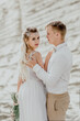 © Valery - The bride and groom on the background of sand. Beautiful couple.