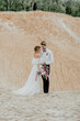 The bride and groom in the sand dunes. Wedding in nature.