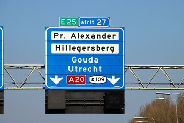 Wall Mural - Blue direction and information sign for the directions on Motorway A16 to Den Haag and Gouda (A20)